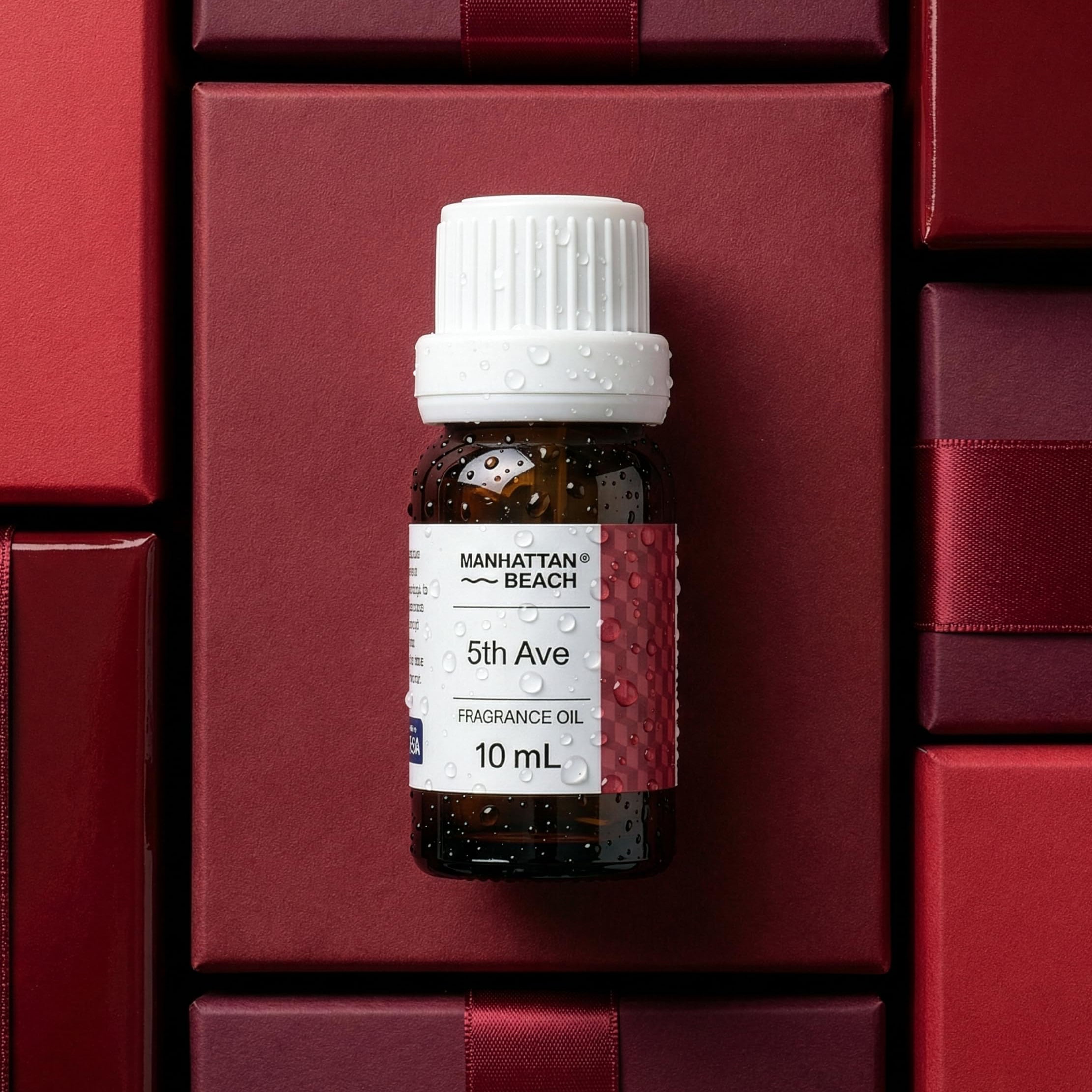 Manhattan Beach 5th Ave fragrance oil bottle on a red background