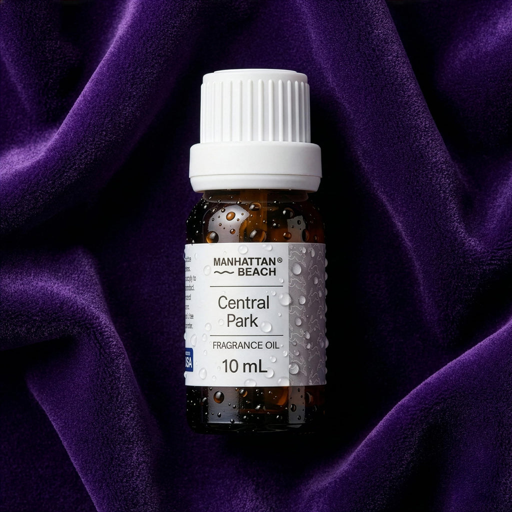 Bottle of Manhattan Beach Central Park fragrance oil on a purple fabric background