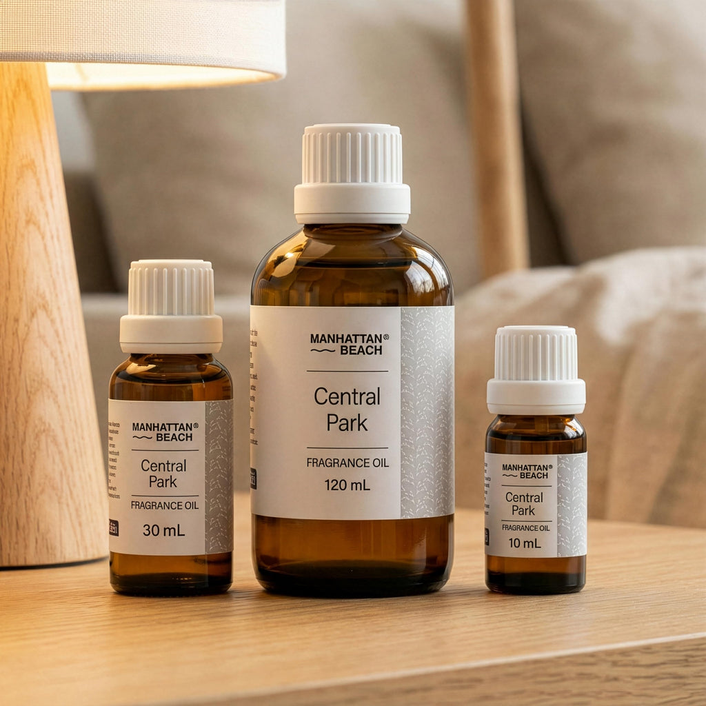 Three bottles of Manhattan Beach Central Park fragrance oil on a wooden surface.